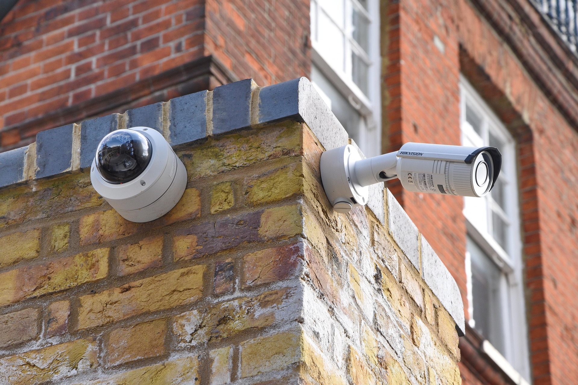 Cámaras de videovigilancia domo y bullet en la fachada de un edificio